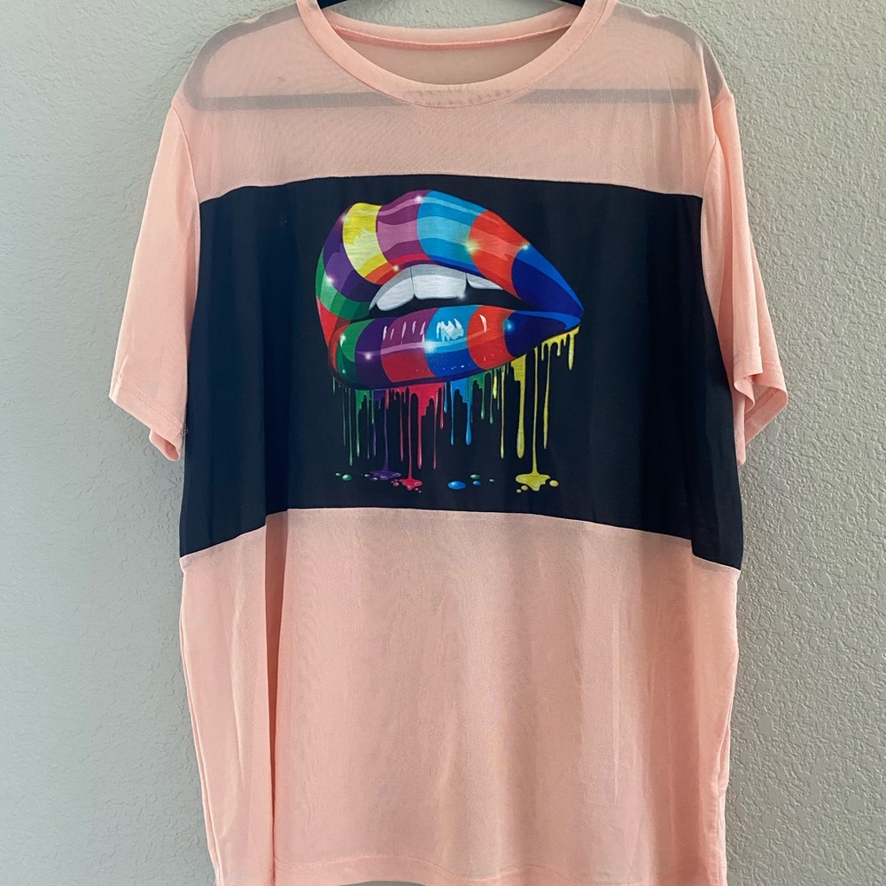 Sheer coral color tee. Multi-color/rainbow lip.